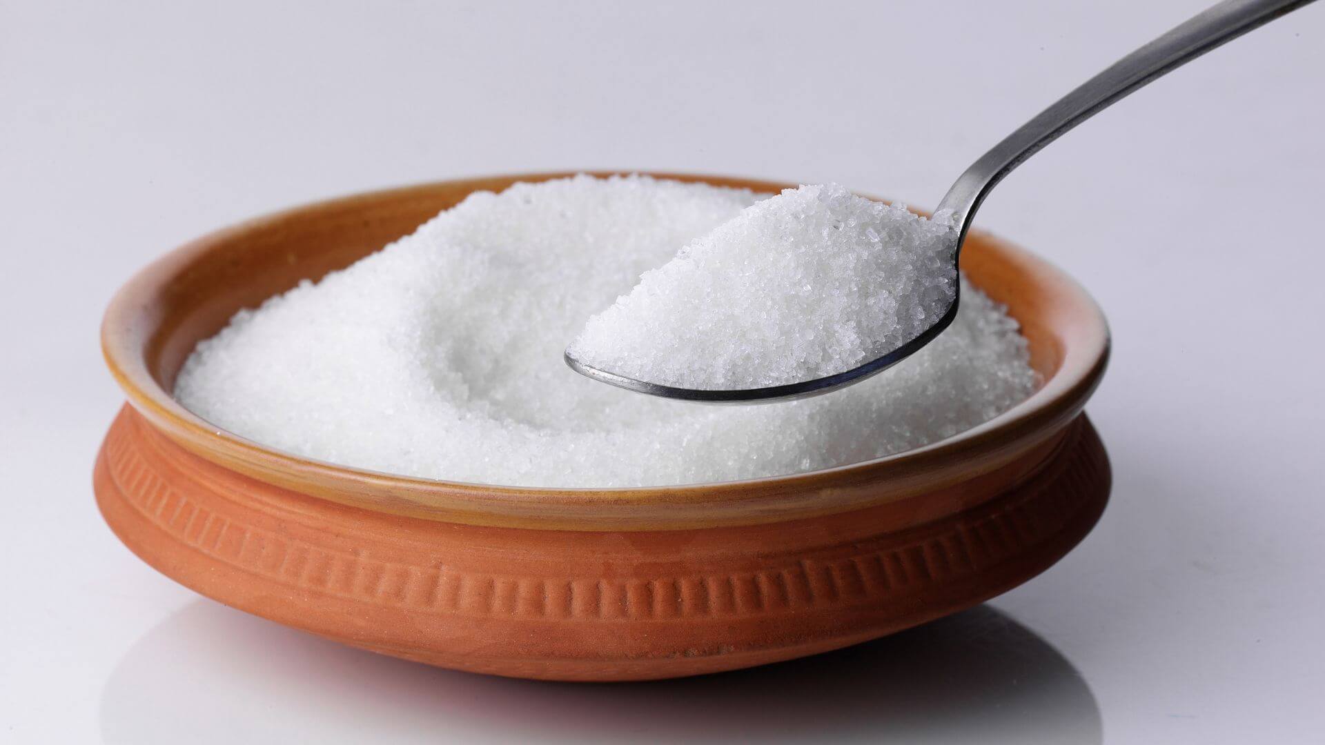 image of a bowl of sugar with a spoon